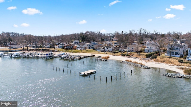 property view of water featuring a boat dock and a residential view