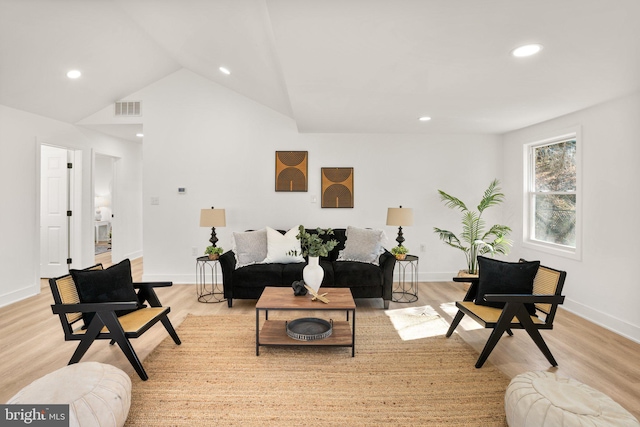 living room featuring visible vents, baseboards, light wood-style flooring, vaulted ceiling, and recessed lighting