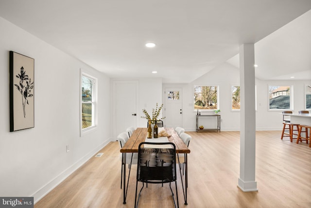 dining area with baseboards, light wood finished floors, and recessed lighting