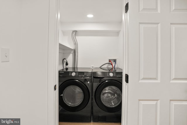 laundry area with laundry area, separate washer and dryer, and recessed lighting