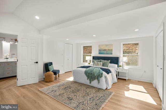 bedroom with lofted ceiling, a closet, light wood finished floors, and recessed lighting