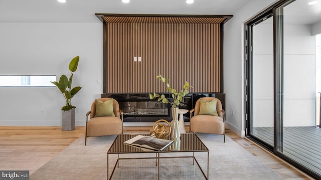 sitting room featuring recessed lighting, wood finished floors, and baseboards