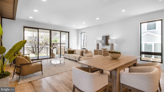dining space featuring light wood finished floors and recessed lighting