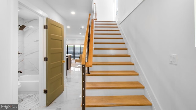 stairway featuring recessed lighting and marble finish floor