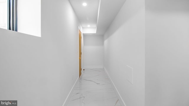 hallway featuring baseboards, marble finish floor, and recessed lighting