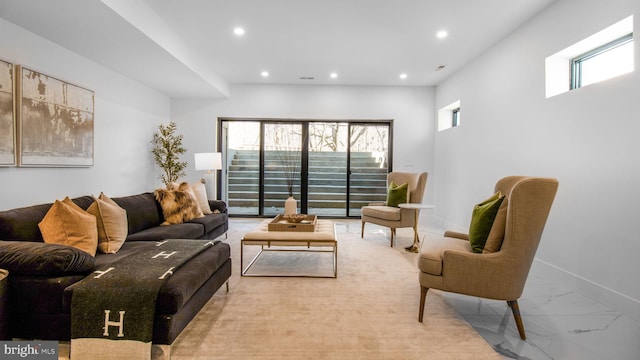 living room with recessed lighting, marble finish floor, and baseboards