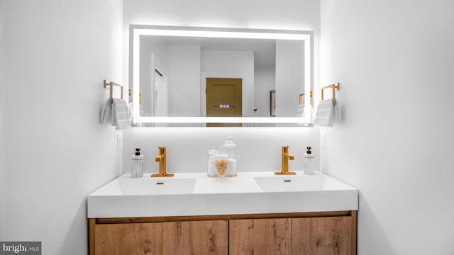 bathroom featuring a sink and double vanity