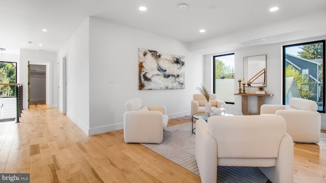 sitting room with a wealth of natural light, light wood-type flooring, and recessed lighting
