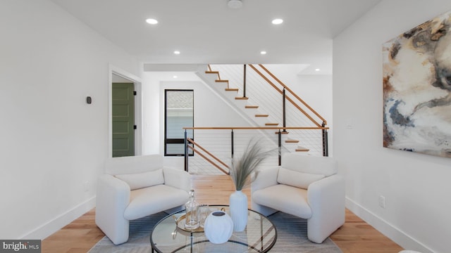 living area with recessed lighting, wood finished floors, and baseboards