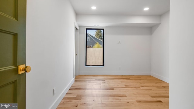 empty room featuring baseboards, recessed lighting, and light wood-style flooring