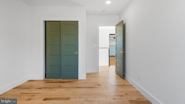 interior space featuring light wood-type flooring, baseboards, and recessed lighting