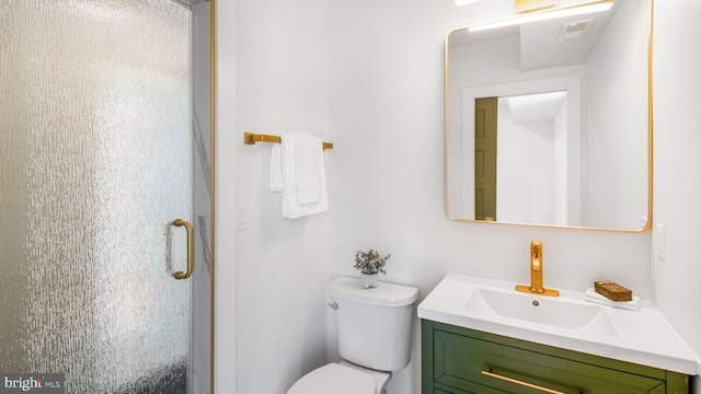 bathroom with a stall shower, vanity, and toilet