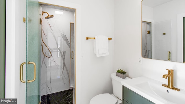 full bath featuring toilet, vanity, and a marble finish shower