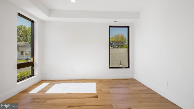 empty room featuring recessed lighting, wood finished floors, and baseboards