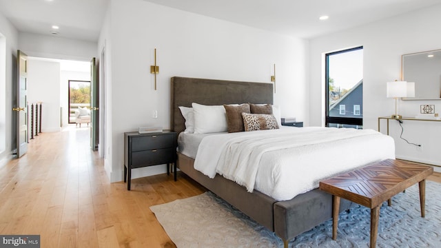 bedroom featuring recessed lighting, light wood-type flooring, and multiple windows