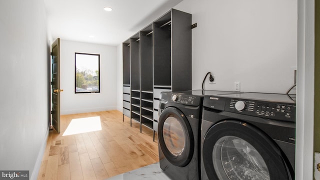 washroom with light wood finished floors, washing machine and dryer, baseboards, recessed lighting, and laundry area