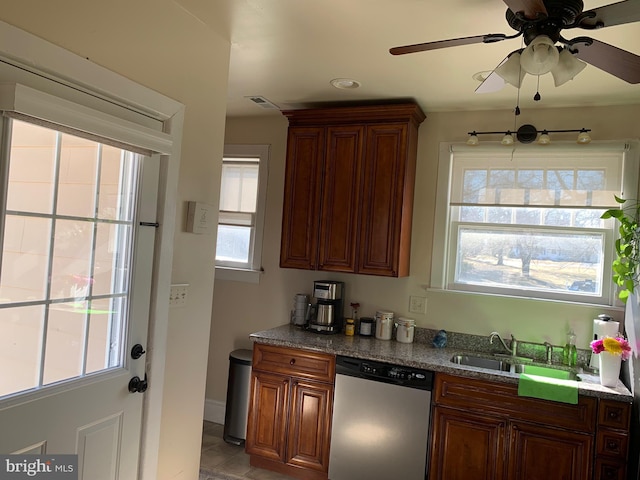 kitchen with stone counters, a sink, visible vents, a ceiling fan, and dishwasher