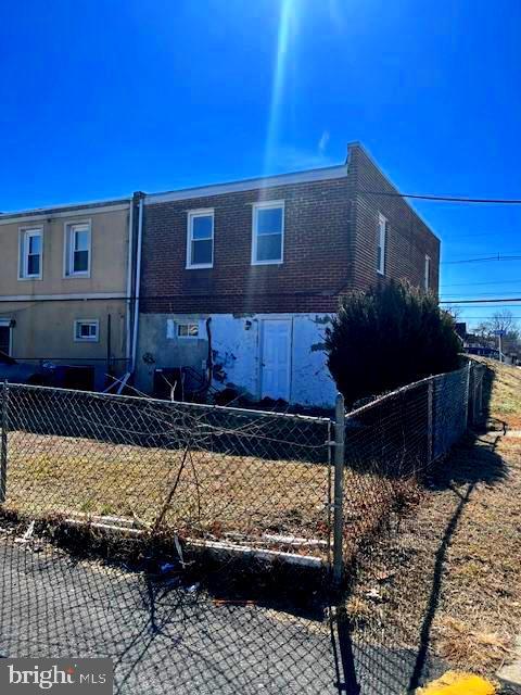 back of property featuring fence