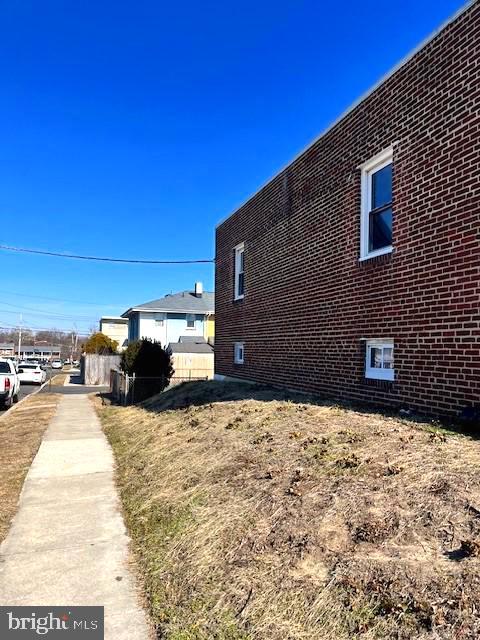 view of side of home featuring brick siding