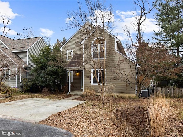 view of front of property with fence and central AC unit