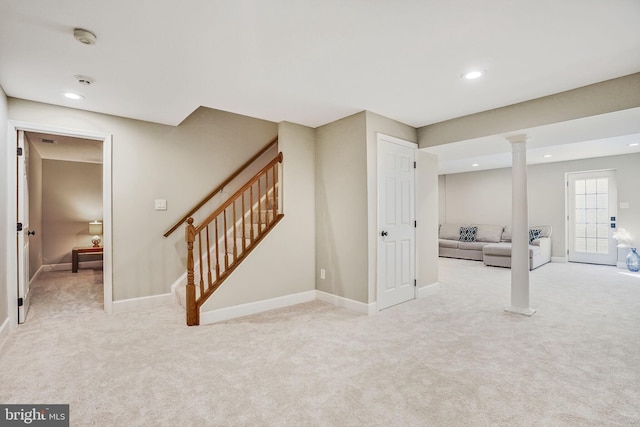 basement with carpet, stairs, and baseboards