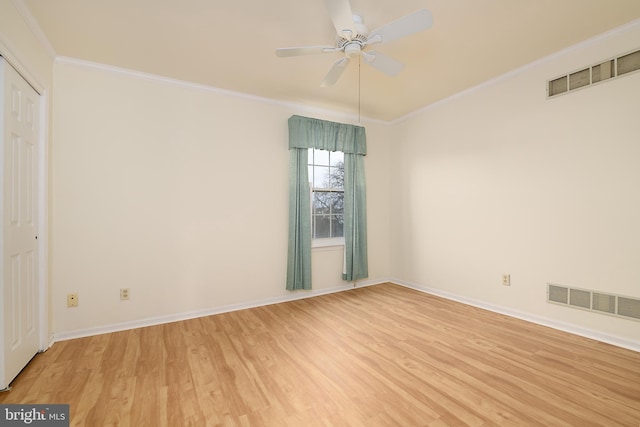 unfurnished room featuring visible vents, light wood-style flooring, crown molding, baseboards, and ceiling fan