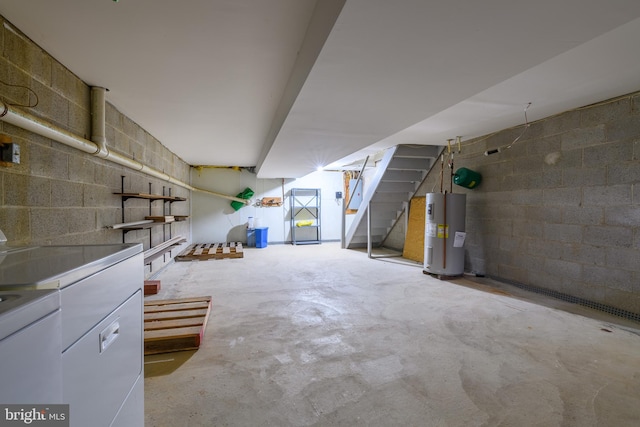 finished below grade area with washer and dryer, stairway, concrete block wall, and water heater