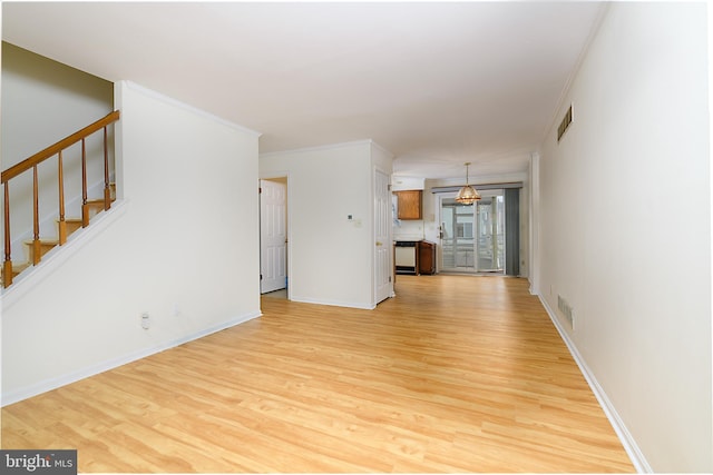 unfurnished living room featuring light wood-type flooring, stairway, visible vents, and crown molding