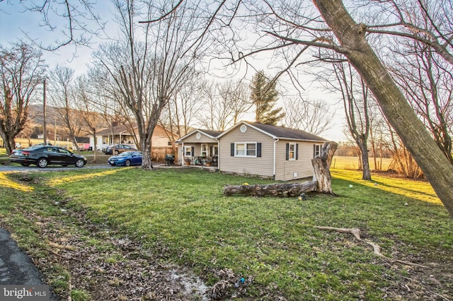 view of front of home with covered porch and a front lawn