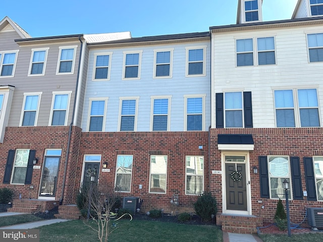 multi unit property featuring central AC unit and brick siding