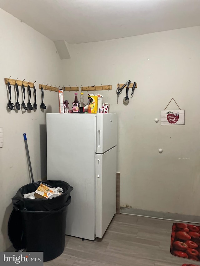 kitchen with light wood finished floors and freestanding refrigerator