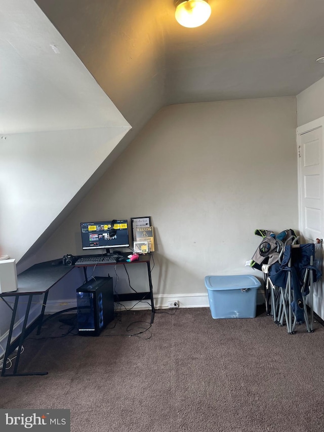 interior space with carpet floors, lofted ceiling, and baseboards