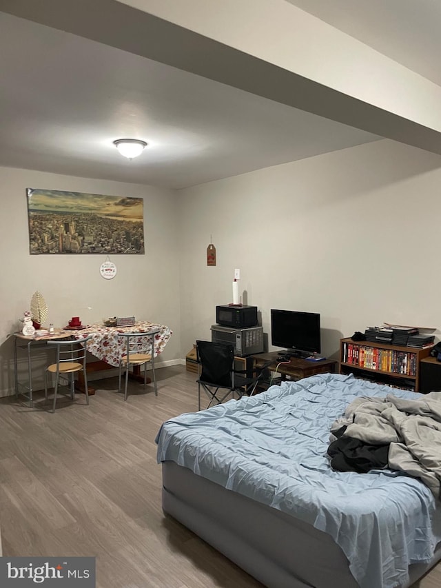 bedroom featuring baseboards and wood finished floors