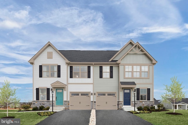 view of front facade featuring a garage, a shingled roof, stone siding, driveway, and a front yard