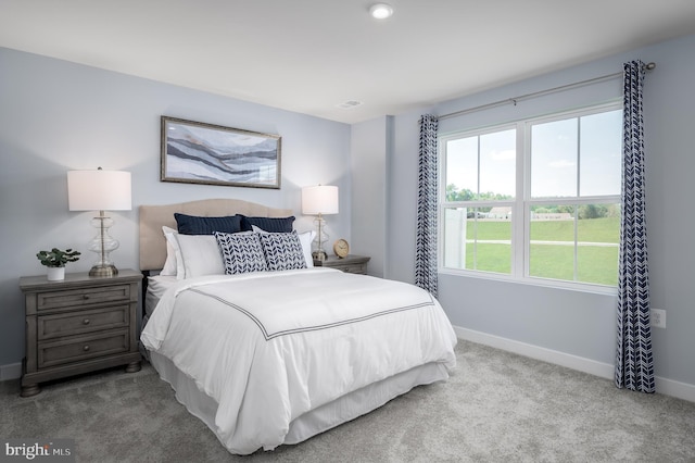 carpeted bedroom with visible vents and baseboards