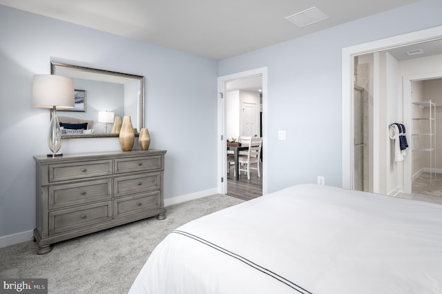 bedroom with visible vents, light colored carpet, and baseboards