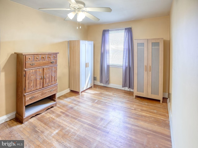 bedroom featuring light wood-type flooring, baseboards, and ceiling fan