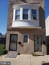 view of front of property featuring fence