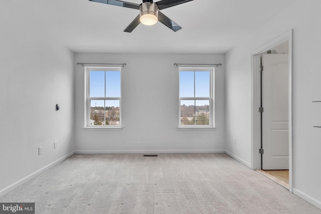 unfurnished bedroom with ceiling fan, carpet flooring, visible vents, and baseboards