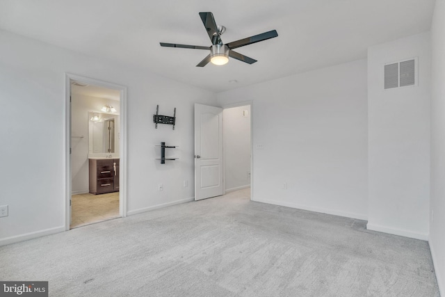 unfurnished bedroom with carpet floors, visible vents, baseboards, and a ceiling fan