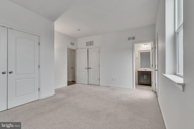 unfurnished bedroom featuring carpet floors, visible vents, and baseboards