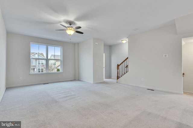 spare room with carpet, stairs, and baseboards