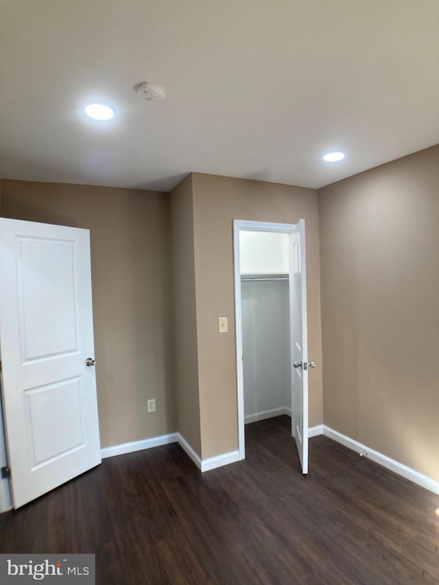 interior space featuring dark wood-style floors, baseboards, and recessed lighting