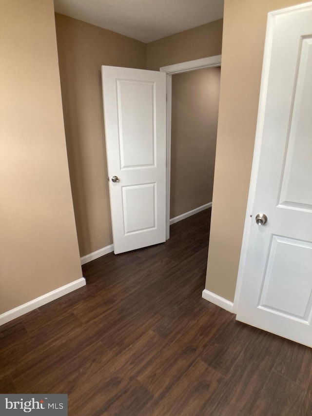 interior space featuring dark wood-style floors and baseboards