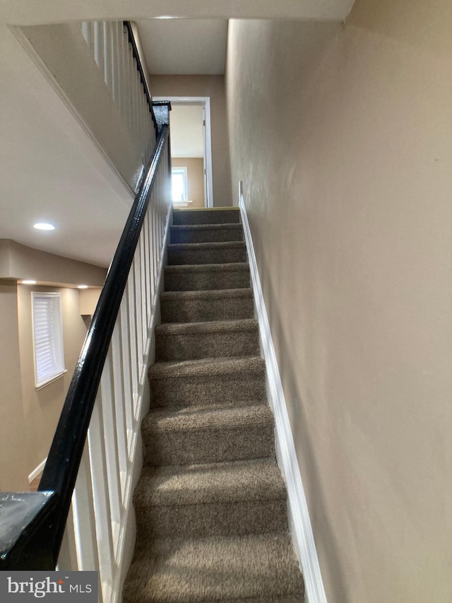 stairway with carpet and baseboards