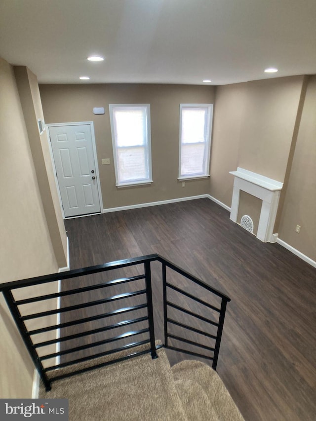 interior space featuring dark wood-style floors, baseboards, and recessed lighting