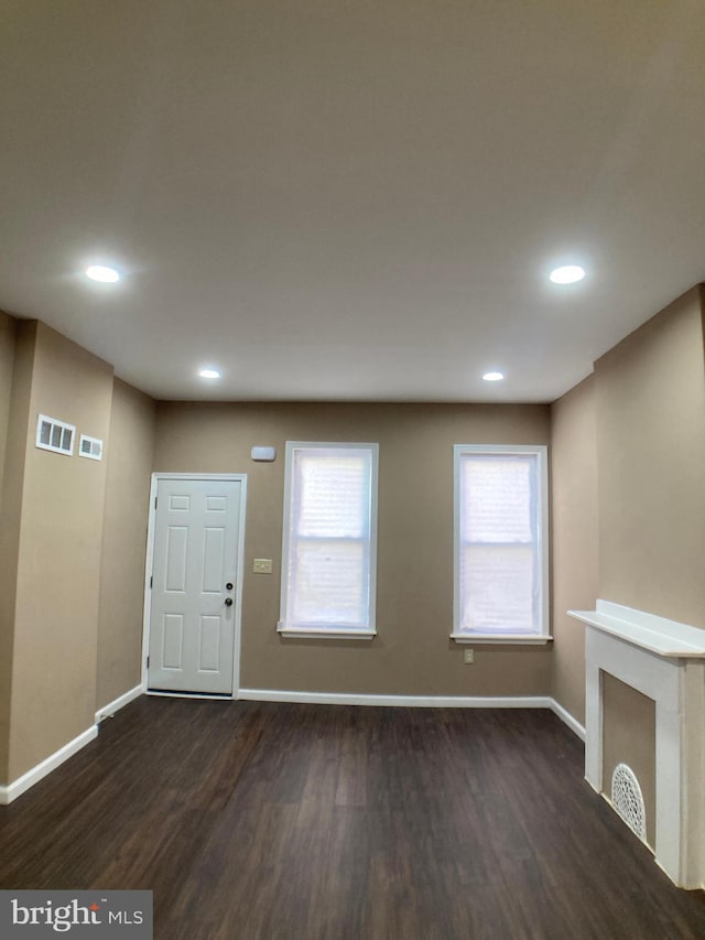 foyer featuring dark wood-type flooring, recessed lighting, and baseboards