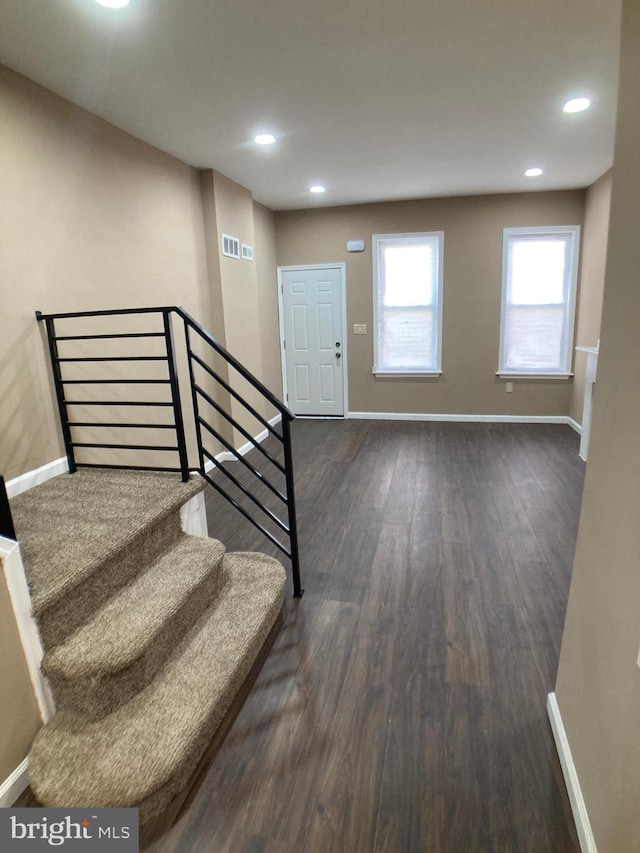 entryway featuring stairway, recessed lighting, dark wood finished floors, and baseboards