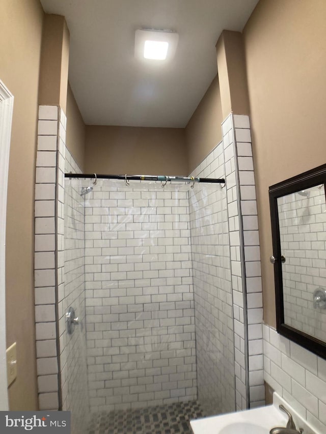 full bathroom with a shower stall and a sink