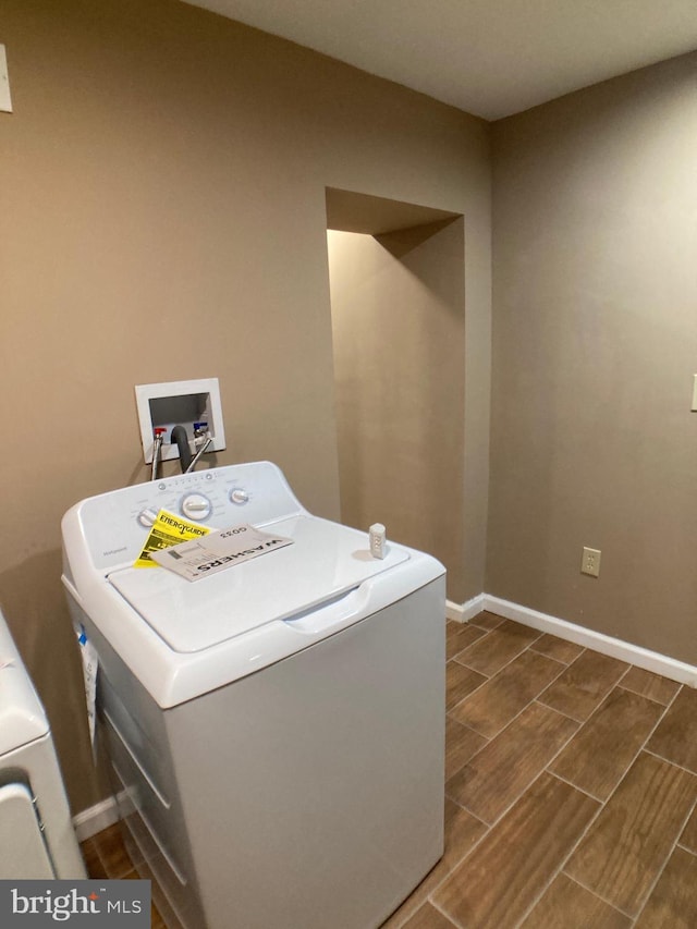 laundry area featuring wood finish floors, washer / clothes dryer, baseboards, and laundry area